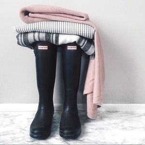 Tall matte black hunter boots.